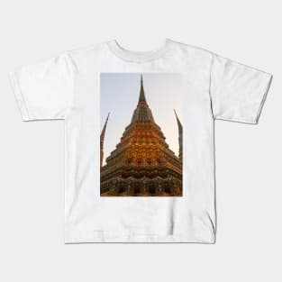 Low angle view of a Buddha stupa reaching symmetrical in the clear sky. Kids T-Shirt